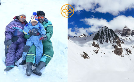 Skiers on a snow slope with an igloo camp in Manali